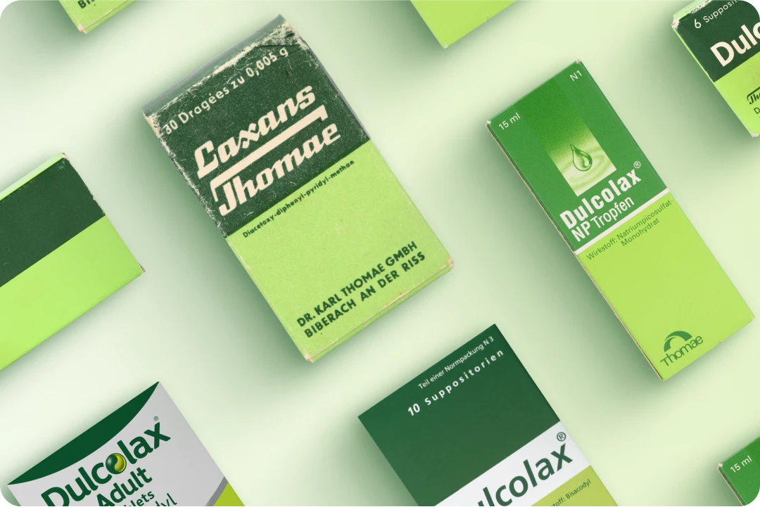 Various packages of medical products, including "Laxans Thomae" and "Dulcolax NP Tropfen."
